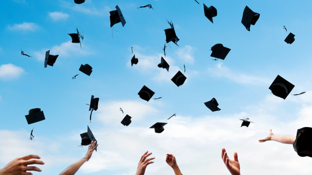 graduation caps in air